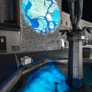 PART VIII 
2022 Bressanone, Italy,
“The White Tower” in Brixen

Analogue Light installation and projection through melt water from Kangerlussuaq, crude oil from Texas and endangered blue cornflower.

Ice melt and oil dilemma.

Selected for Brixen Water Light Festival